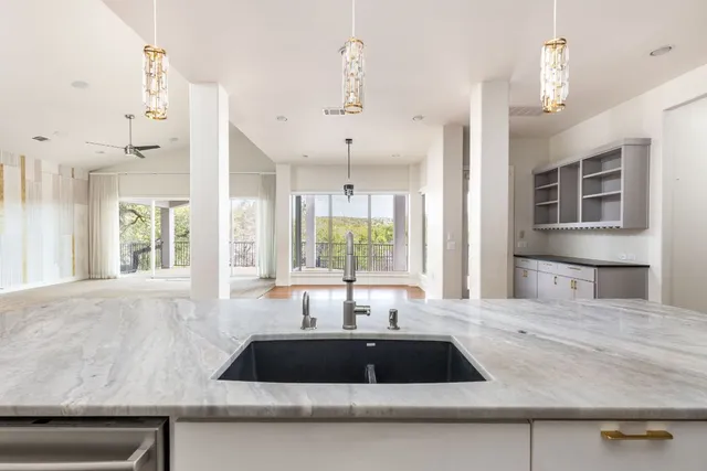 a kitchen with granite countertop a sink and a window