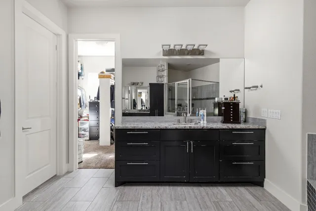a bathroom with a sink vanity and mirror