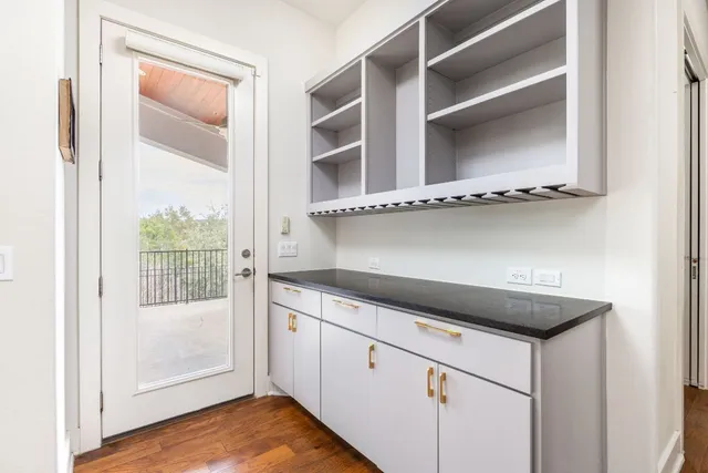 a kitchen with a wooden floor and white cabinet