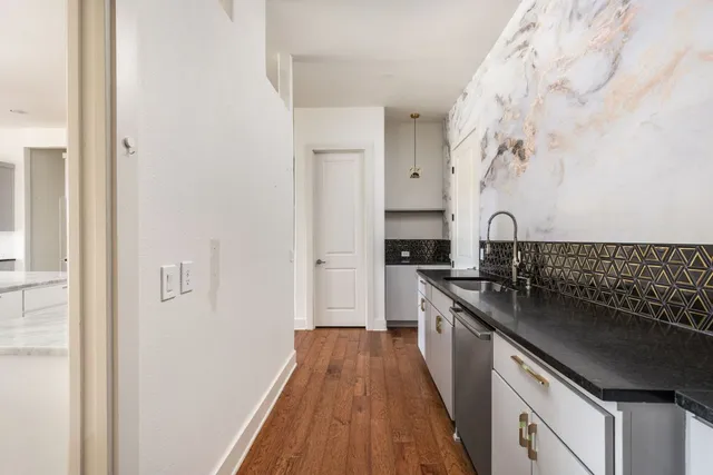 a kitchen with stainless steel appliances granite countertop a stove and a refrigerator