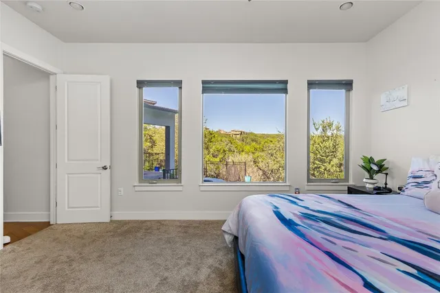 a bedroom with a bed and a large window