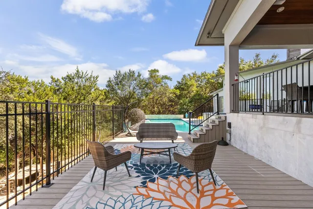 an aerial view of a house with a yard wooden table and chairs