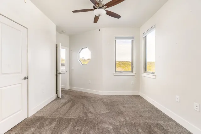 a bathroom with a granite countertop sink a toilet and a mirror