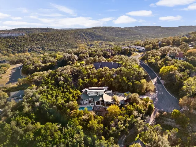an aerial view of a house with a yard