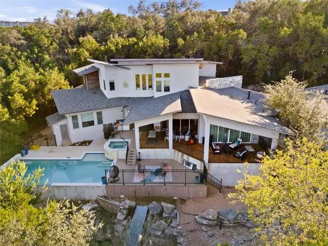 an aerial view of a house with a yard basket ball court and outdoor seating