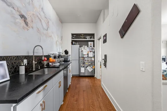 a kitchen with sink refrigerator and stove