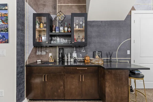 a kitchen with kitchen island granite countertop a sink and cabinets