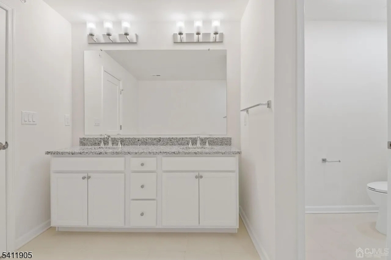 735 Station Road Dunellen, NJ 08812 - Photo 11 of 36 a bathroom with a sink and a mirror