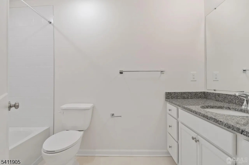 735 Station Road Dunellen, NJ 08812 - Photo 15 of 36 a bathroom with a granite countertop toilet and a sink