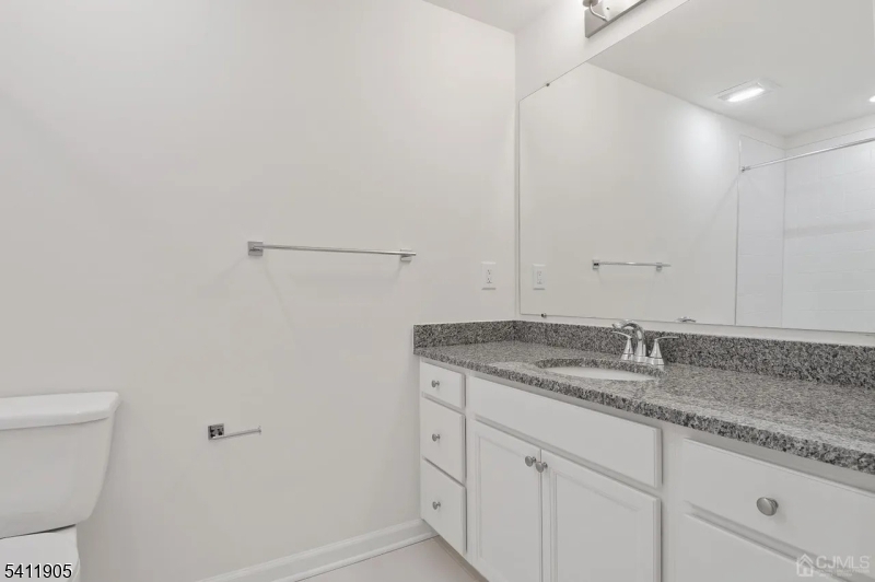 735 Station Road Dunellen, NJ 08812 - Photo 16 of 36 a bathroom with a granite countertop sink and toilet