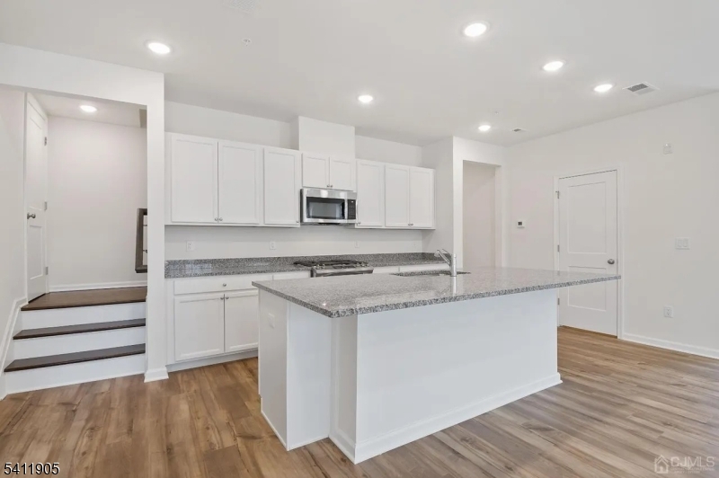 735 Station Road Dunellen, NJ 08812 - Photo 9 of 36 a kitchen with stainless steel appliances granite countertop a stove and a sink