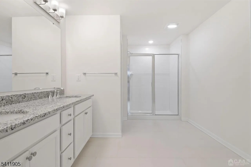 735 Station Road Dunellen, NJ 08812 - Photo 10 of 36 a bathroom with a granite countertop sink and a mirror