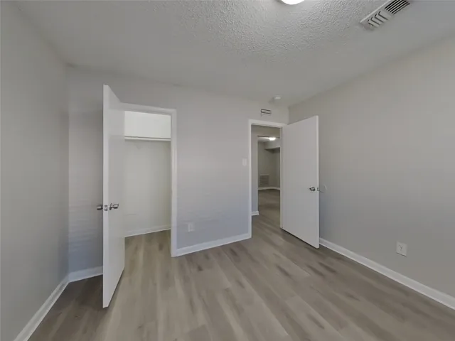 a view of a room with wooden floor