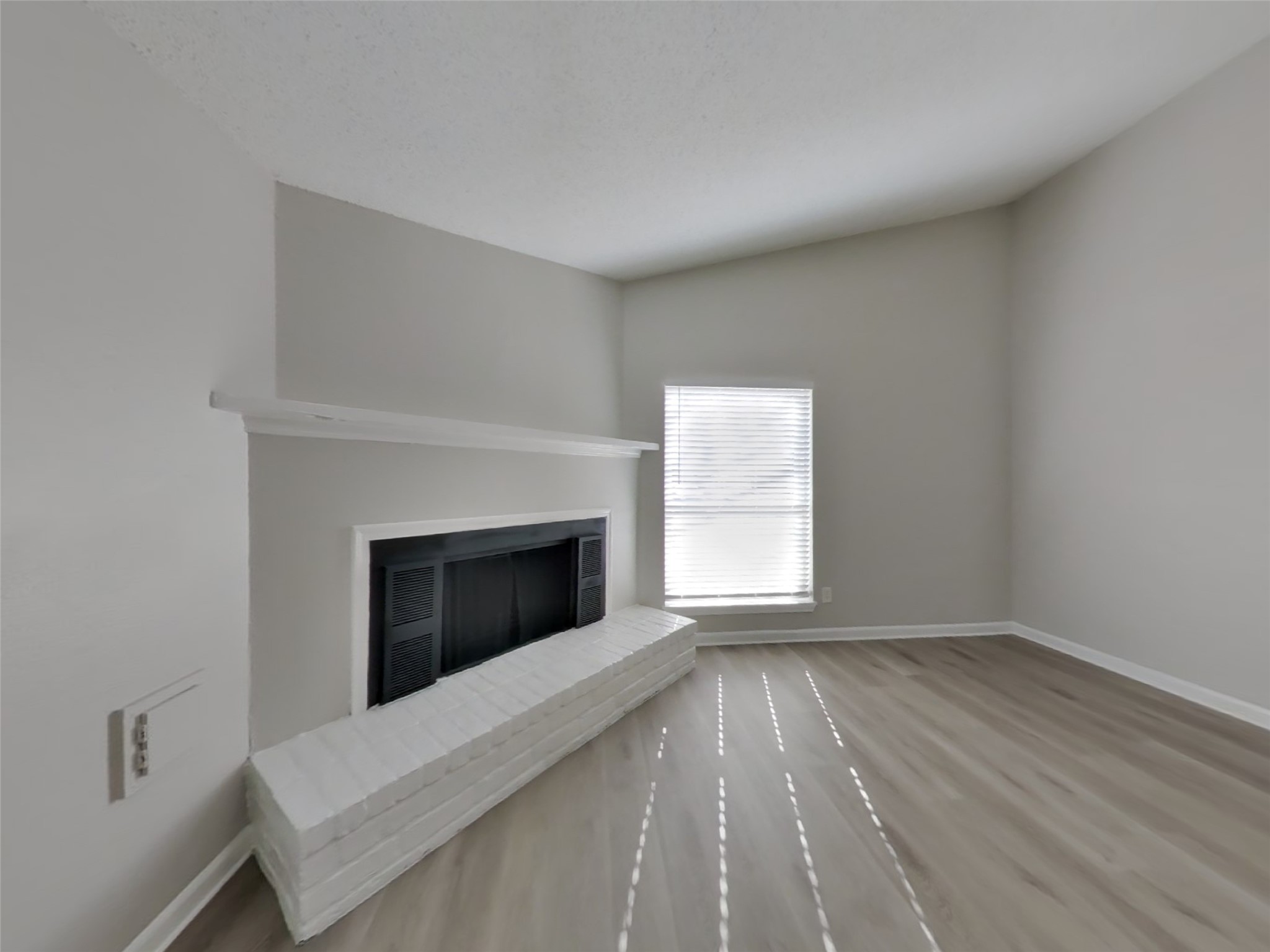 623 Walston Lane Houston, TX 77060 - Photo 2 of 21 a view of an empty room with a fireplace and a window