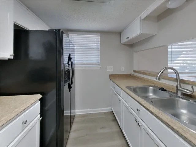a kitchen with a sink and refrigerator