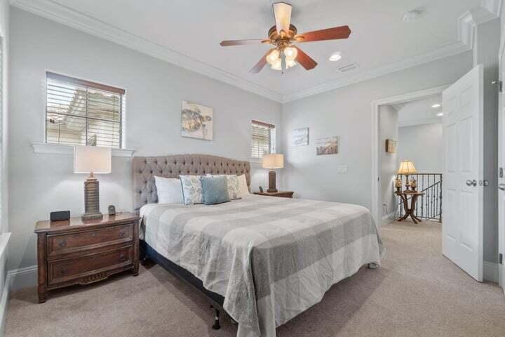 1900 Baytowne Loop Miramar Beach, FL 32550 - Photo 27 of 44 a bedroom with a bed and a chandelier