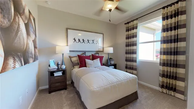 a bedroom with a bed and a chandelier