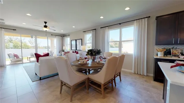a dining room with furniture a window and a kitchen view