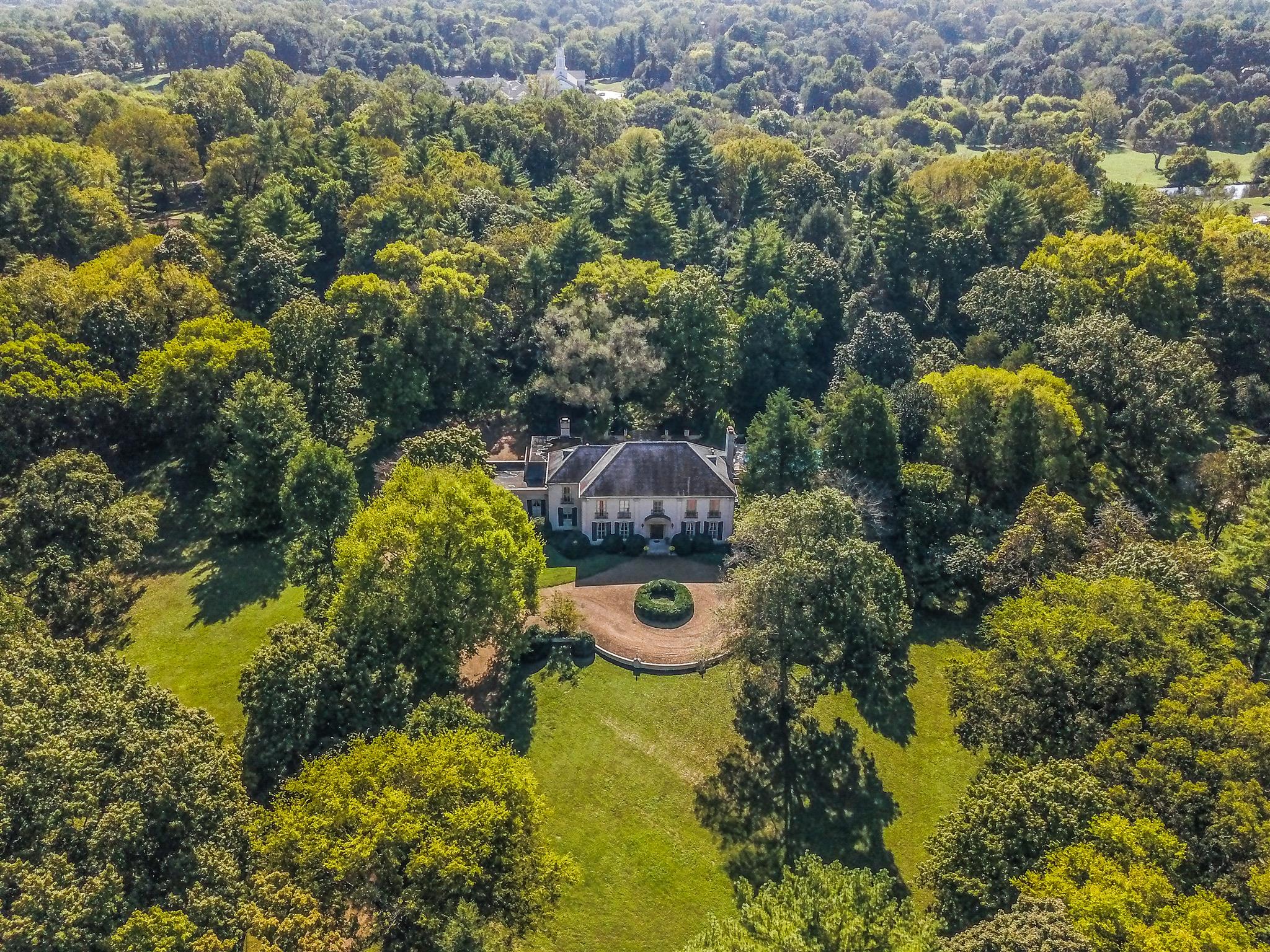 an aerial view of residential house with outdoor space and swimming pool