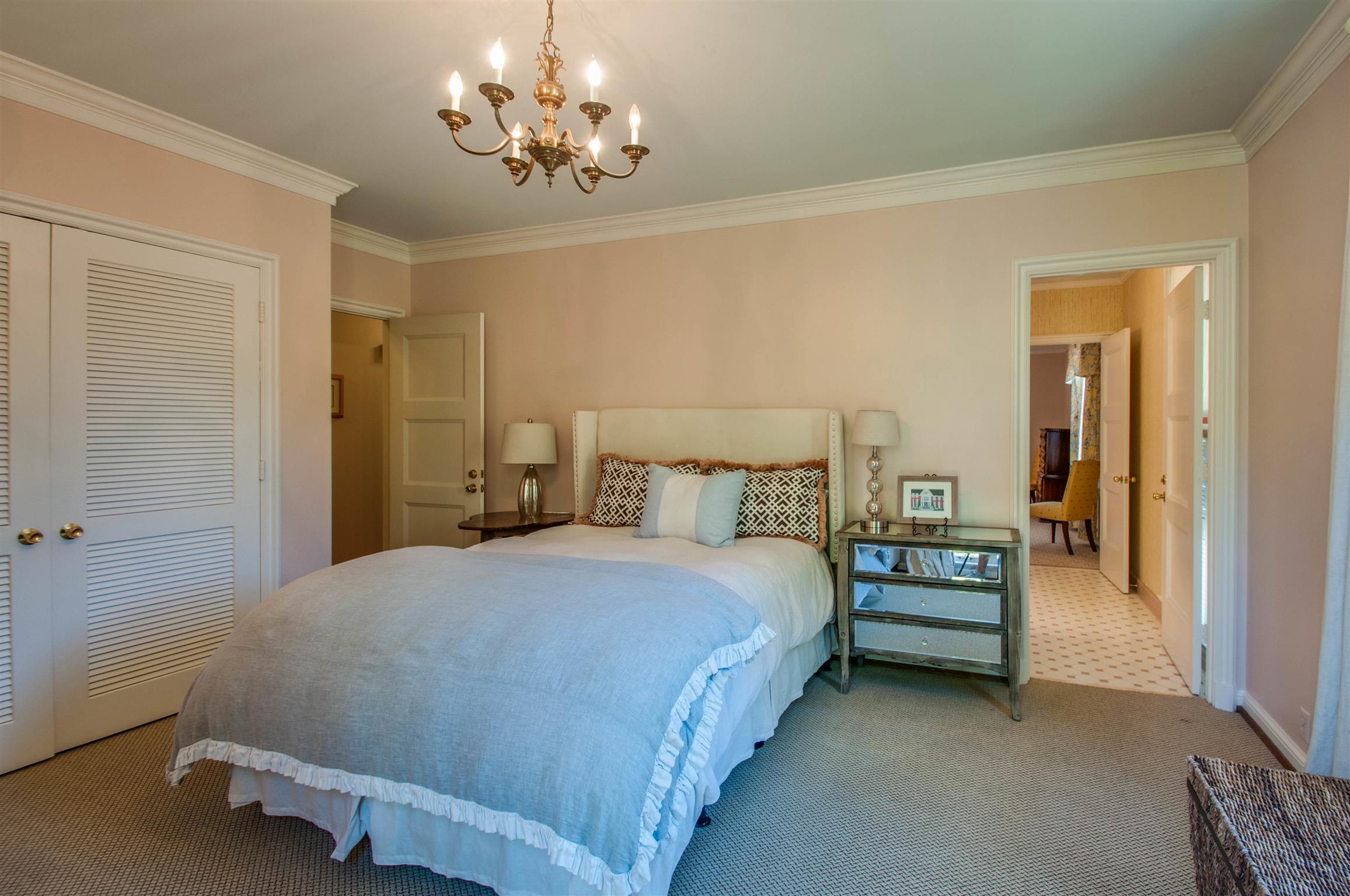 4727 Post Road Nashville, TN 37205 - Photo 20 of 28 a bedroom with a bed and a chandelier