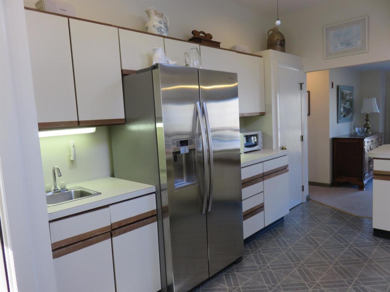 126 Wading Place Road Mashpee, MA 02649 - Photo 13 of 27 a kitchen with stainless steel appliances granite countertop a refrigerator and a sink