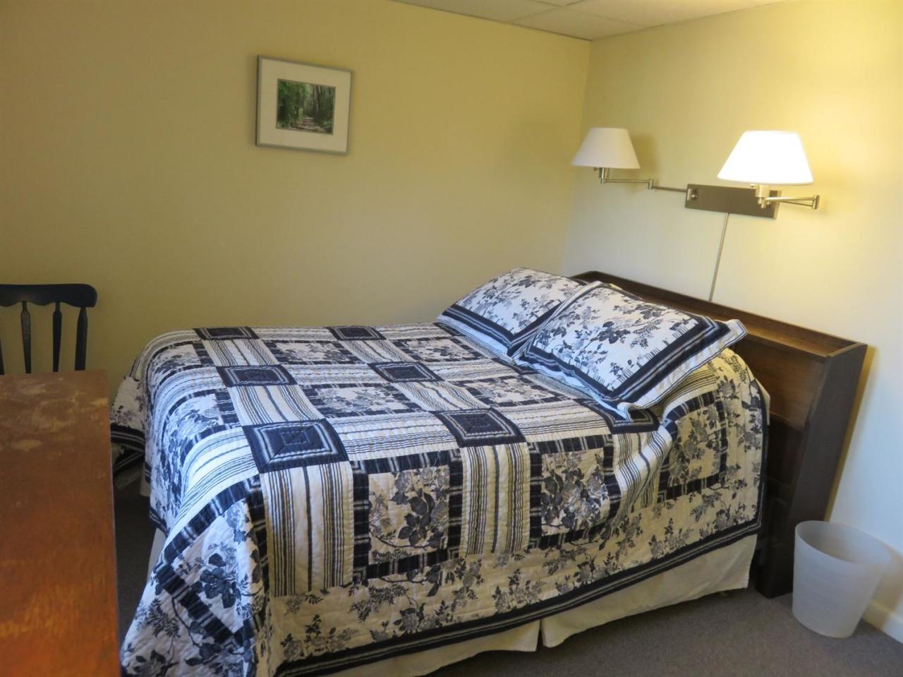 126 Wading Place Road Mashpee, MA 02649 - Photo 22 of 27 a bed sitting in a bedroom next to a lamp