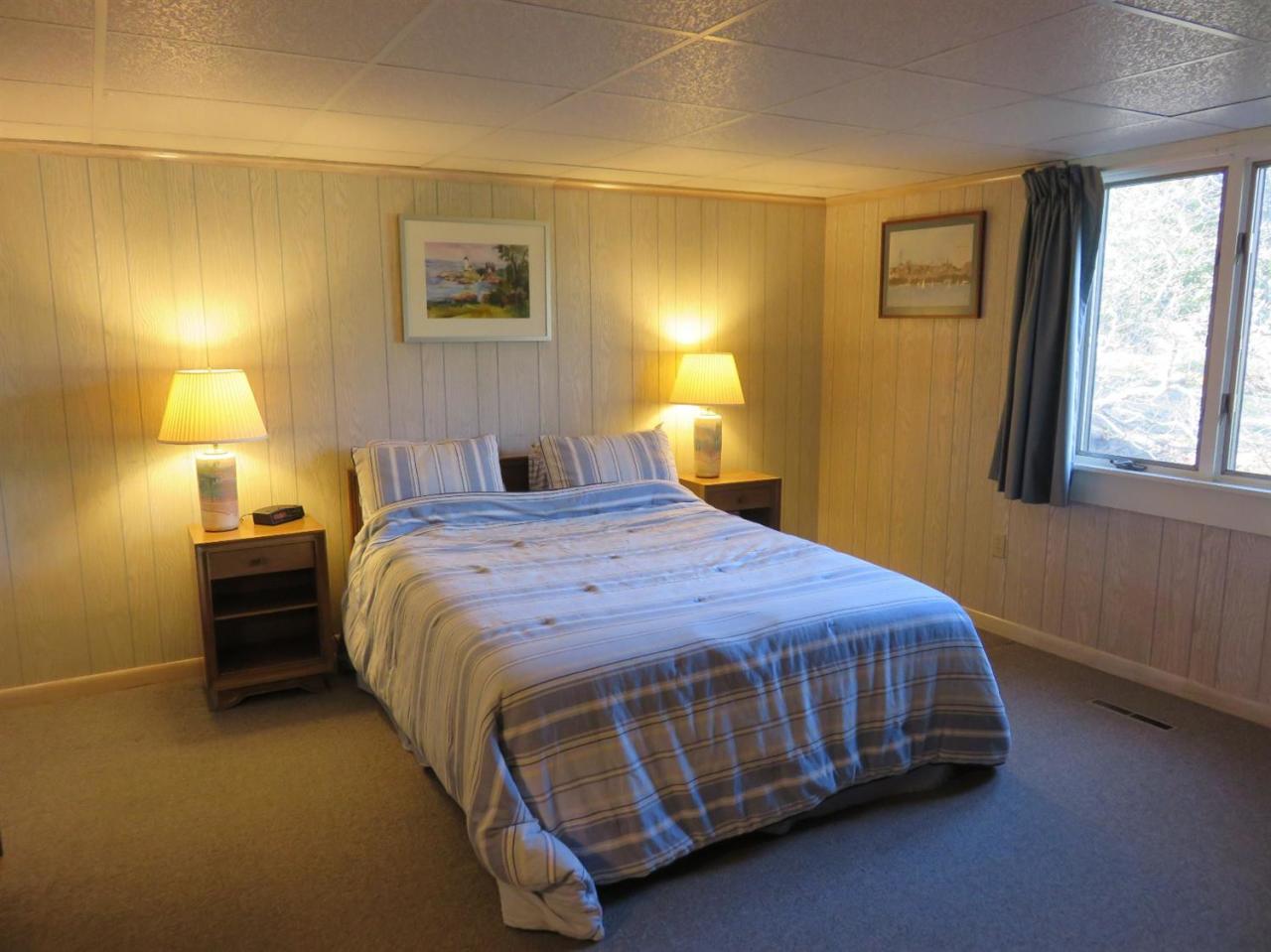 126 Wading Place Road Mashpee, MA 02649 - Photo 23 of 27 a bedroom with a bed and lamp with window