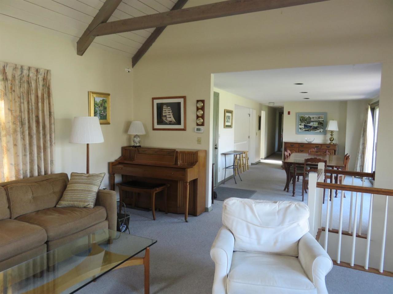 126 Wading Place Road Mashpee, MA 02649 - Photo 25 of 27 a living room with furniture a dining table and a piano table
