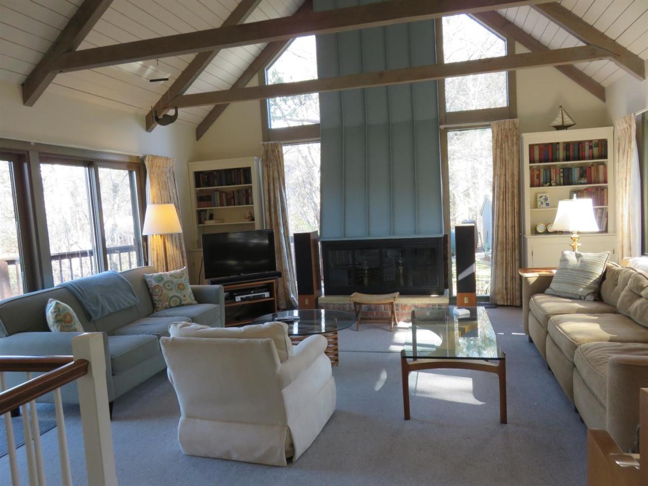 126 Wading Place Road Mashpee, MA 02649 - Photo 6 of 27 a living room with fireplace furniture and a large window