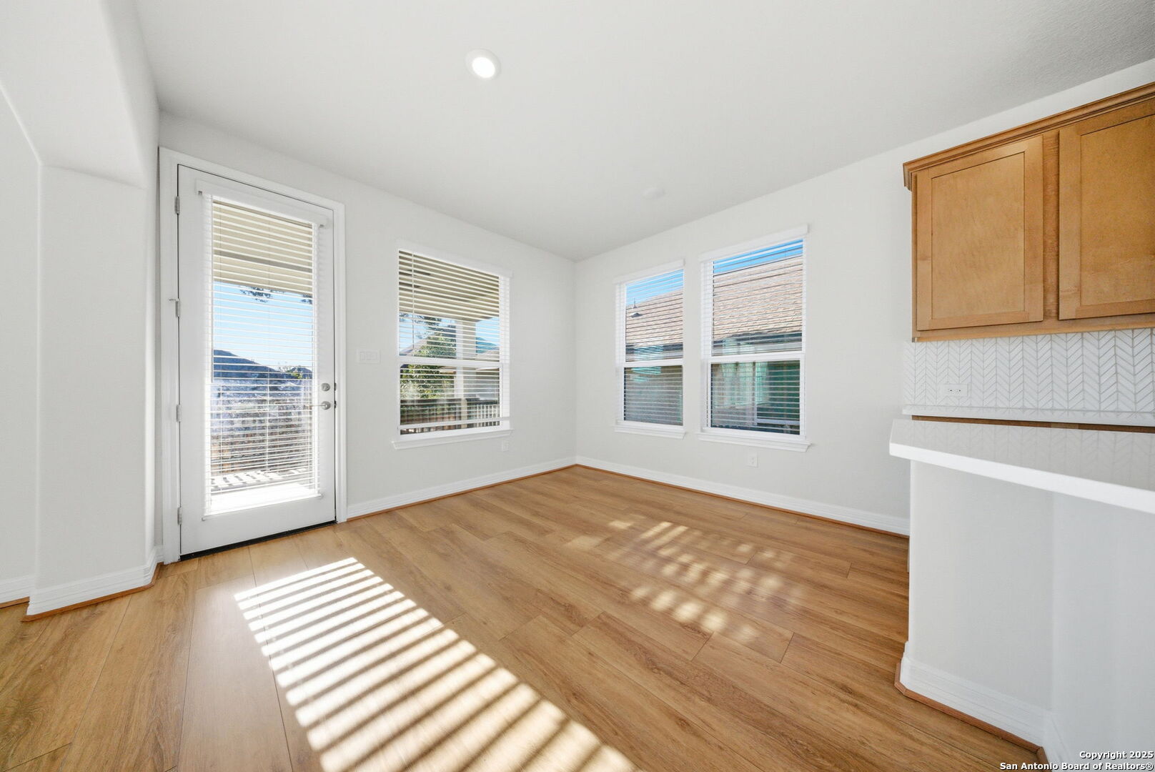 662 Hidden View Street New Braunfels, TX 78130 - Photo 14 of 48 a view of an empty room with window and wooden floor