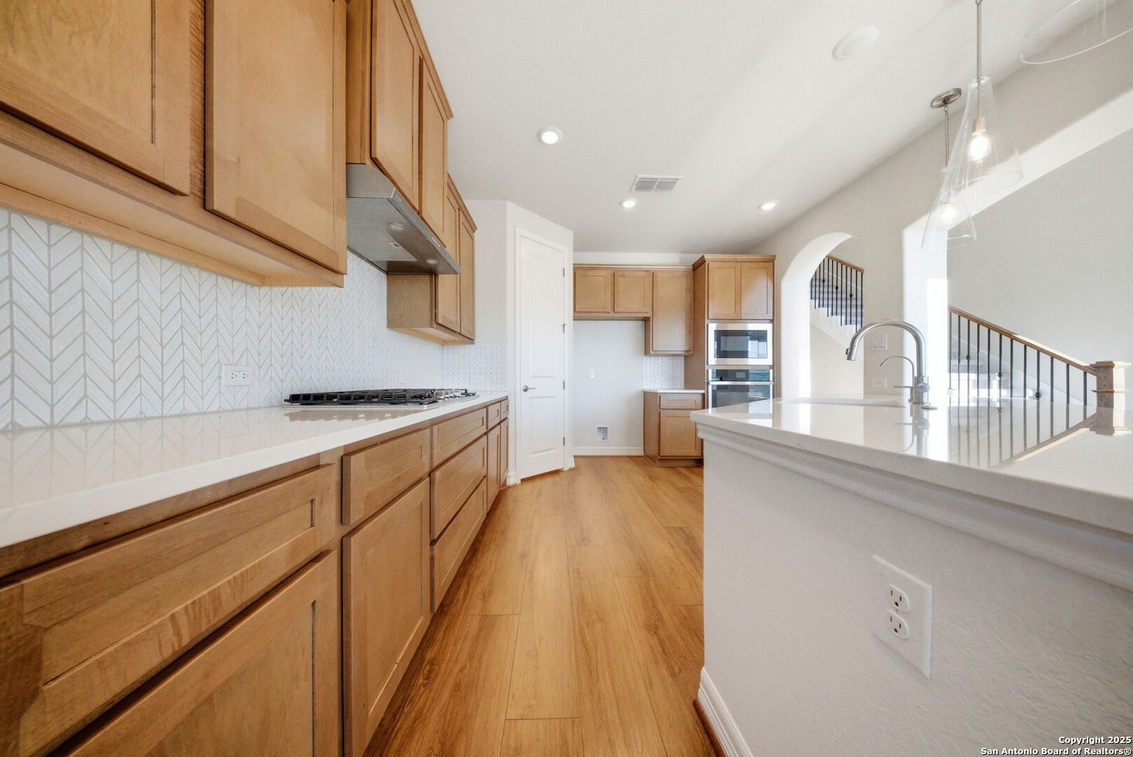 662 Hidden View Street New Braunfels, TX 78130 - Photo 16 of 48 a kitchen with cabinets a sink and wooden floor