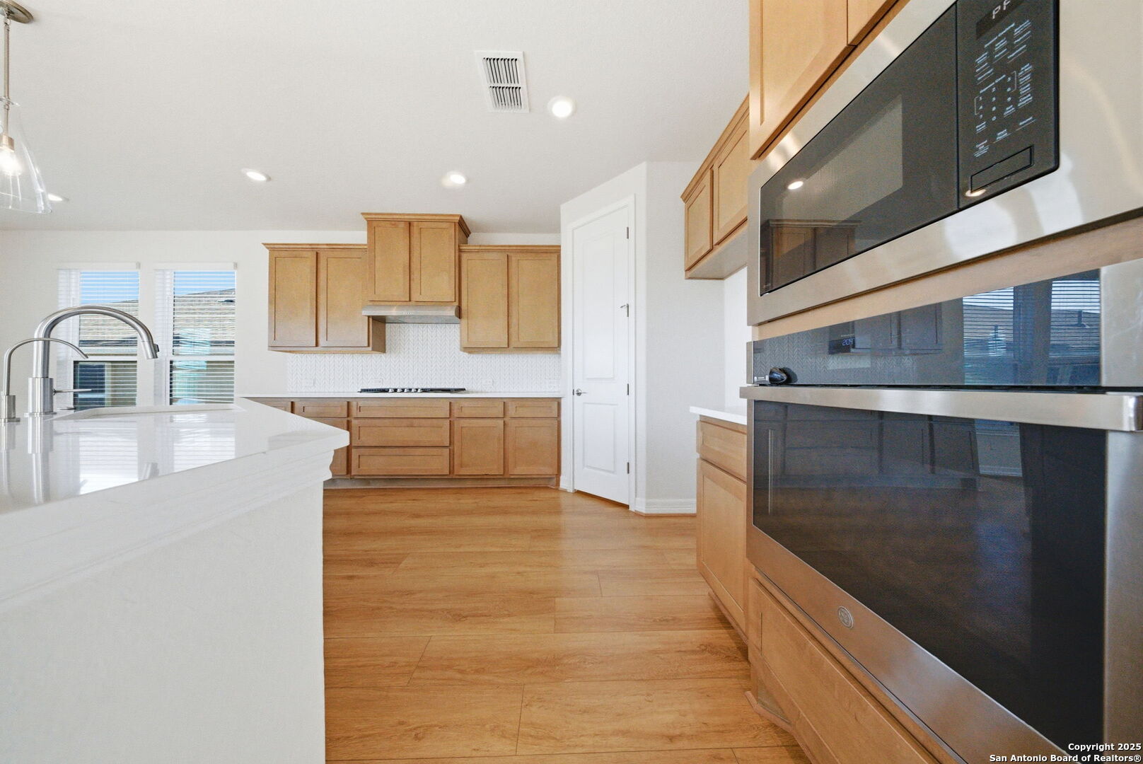 662 Hidden View Street New Braunfels, TX 78130 - Photo 17 of 48 a large kitchen with stainless steel appliances kitchen island granite countertop a large counter top and a stove