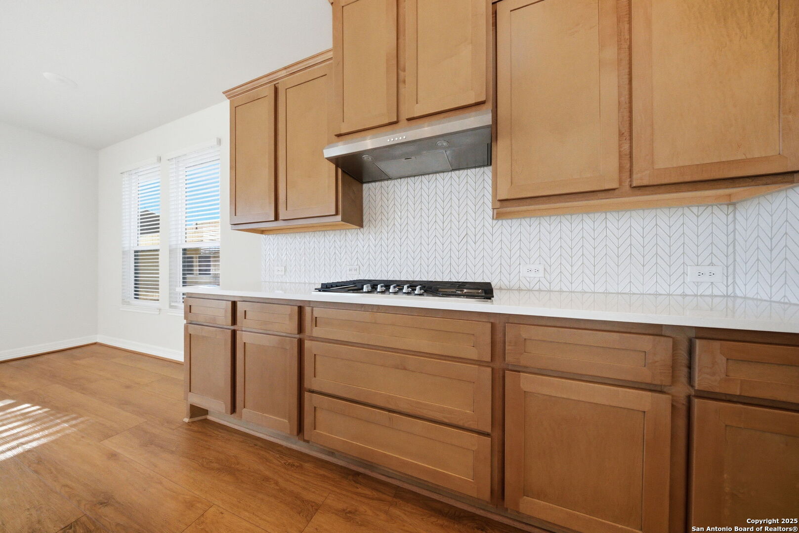 662 Hidden View Street New Braunfels, TX 78130 - Photo 19 of 48 a kitchen with cabinets and a window