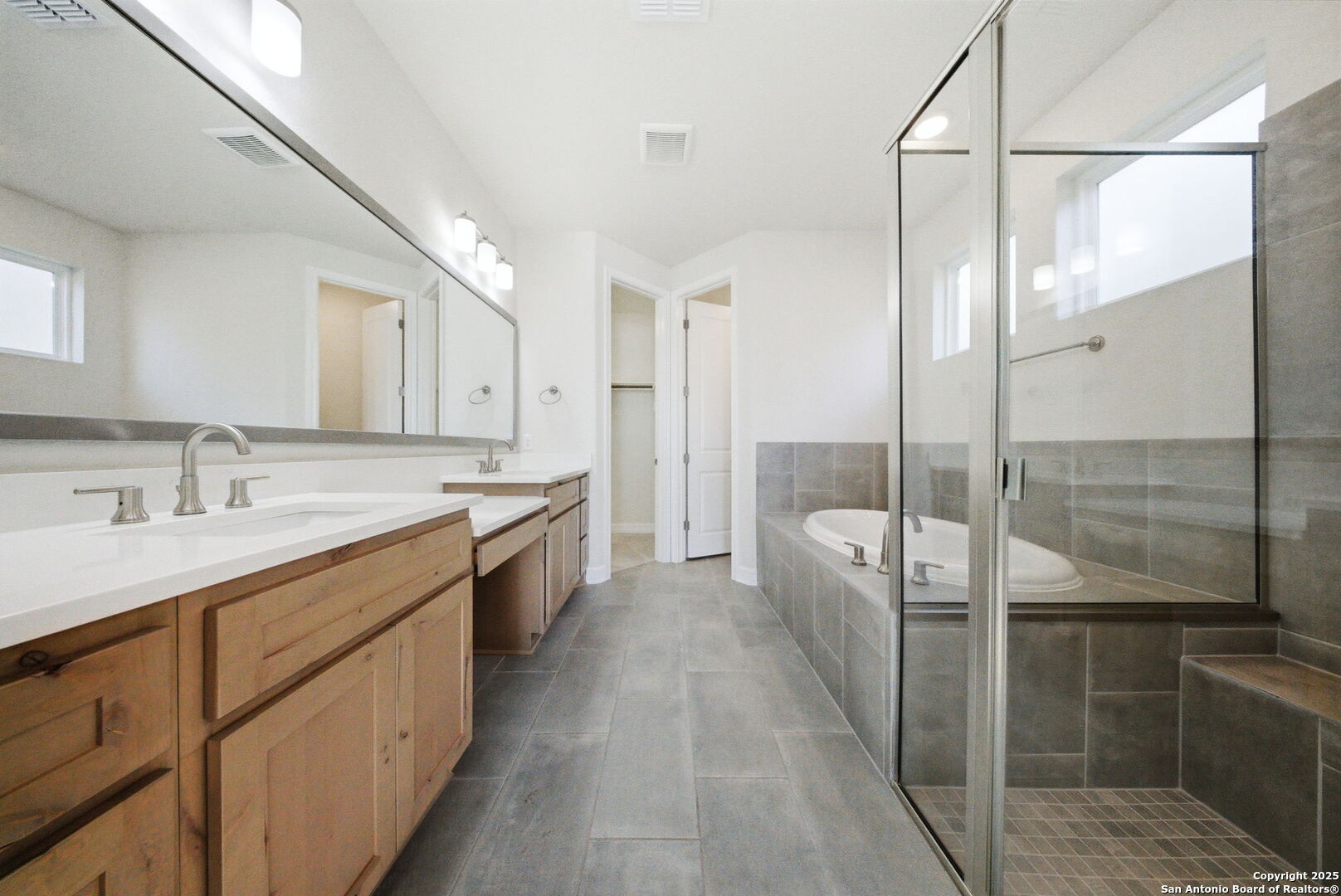 662 Hidden View Street New Braunfels, TX 78130 - Photo 24 of 48 a large bathroom with a double vanity sink a mirror and a shower