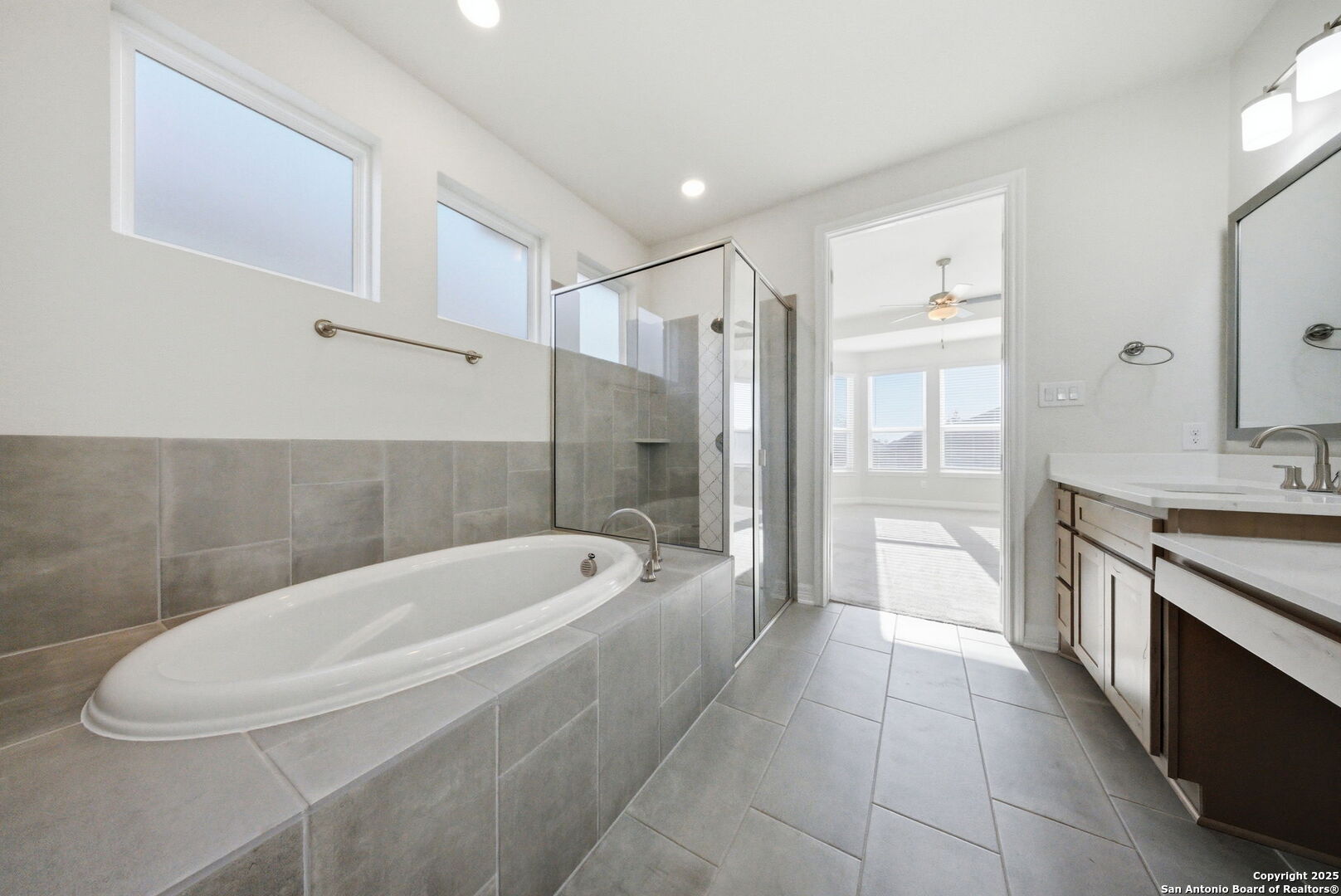 662 Hidden View Street New Braunfels, TX 78130 - Photo 26 of 48 a spacious bathroom with a tub sink and mirror