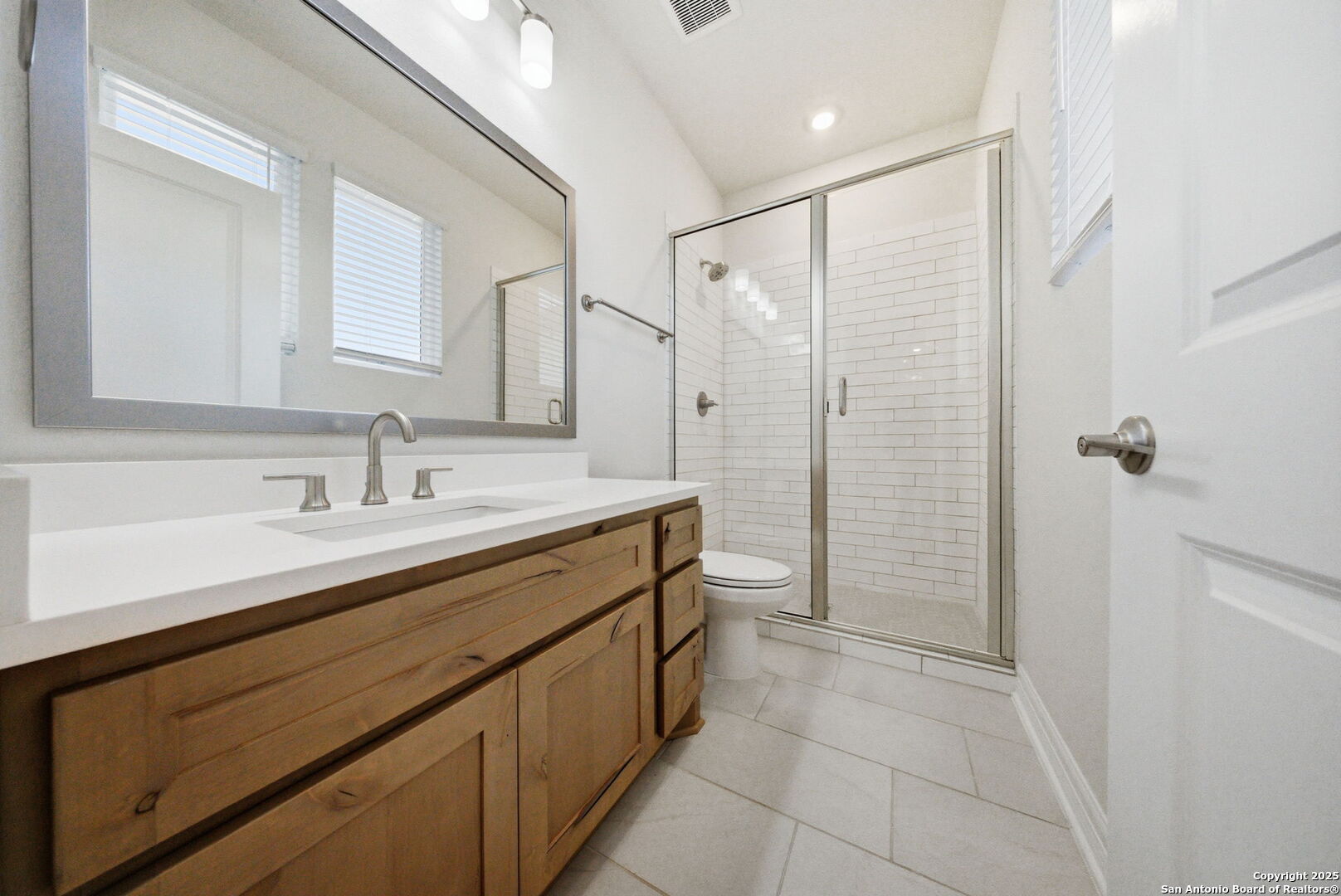 662 Hidden View Street New Braunfels, TX 78130 - Photo 32 of 48 a spacious bathroom with a shower sink and mirror