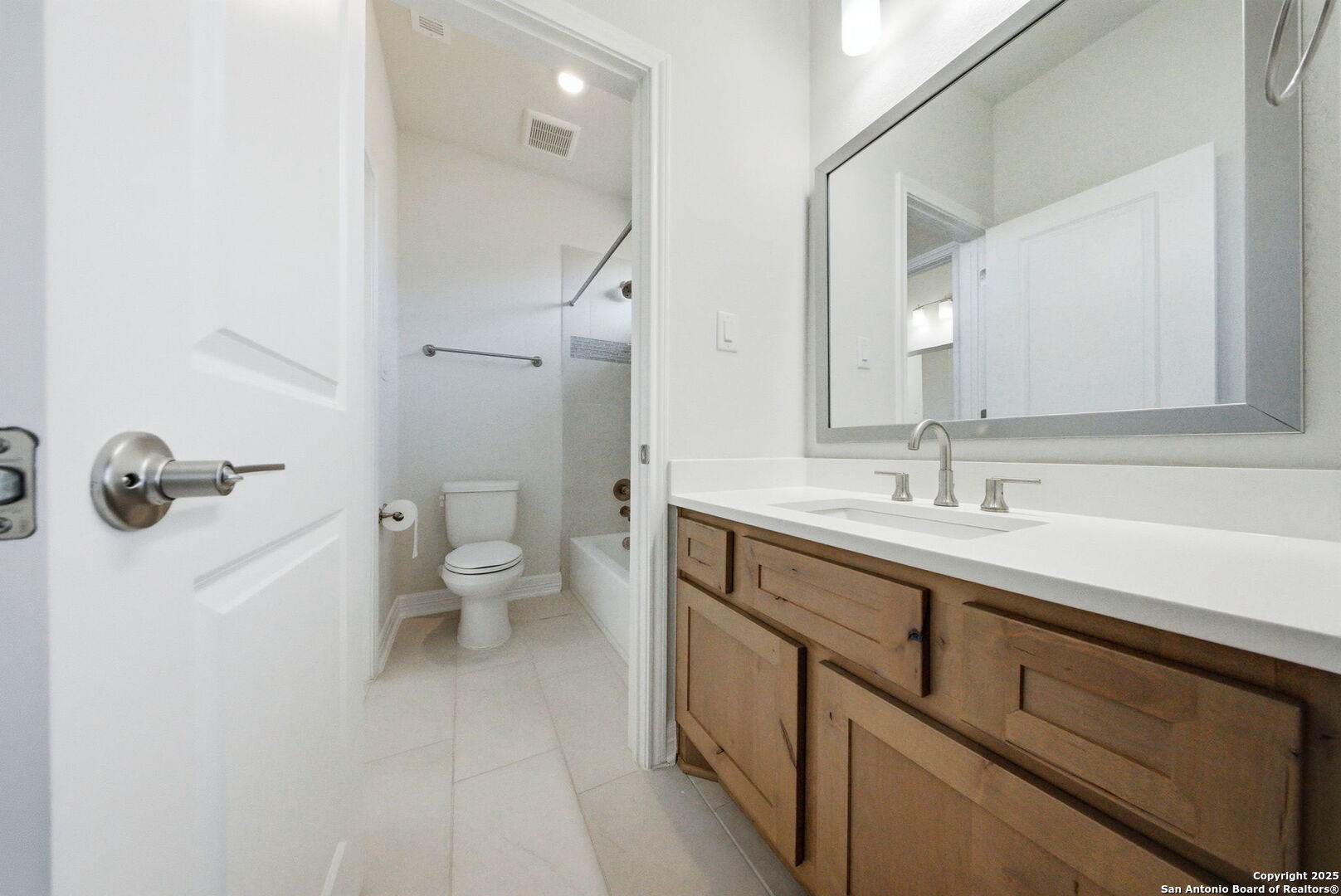 662 Hidden View Street New Braunfels, TX 78130 - Photo 37 of 48 a spacious bathroom with a sink a toilet a shower and a mirror
