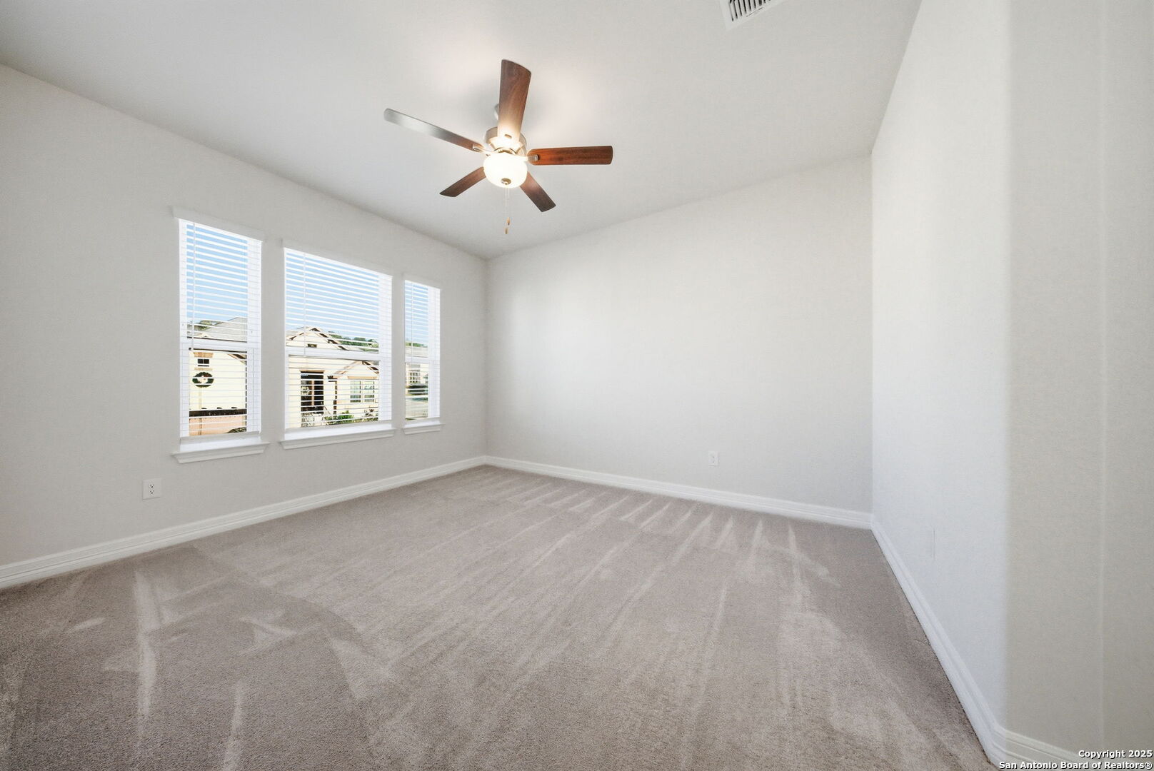 662 Hidden View Street New Braunfels, TX 78130 - Photo 39 of 48 an empty room with windows and fan