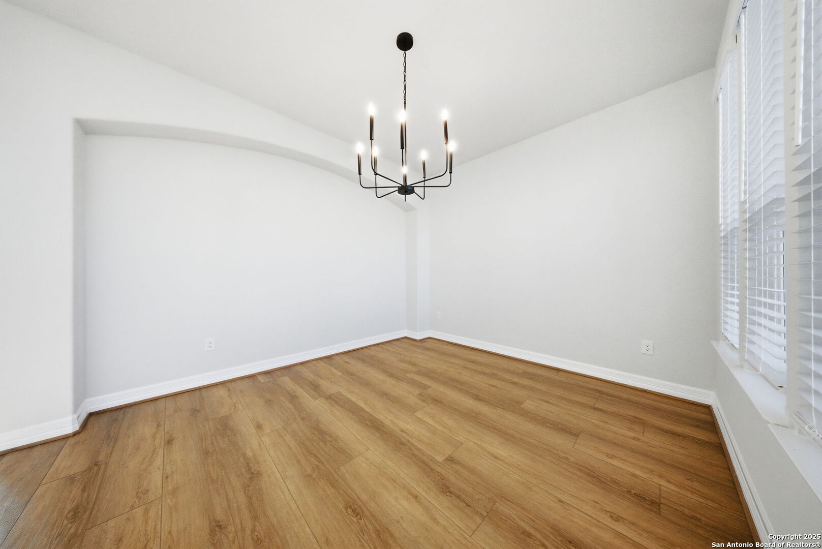 662 Hidden View Street New Braunfels, TX 78130 - Photo 7 of 48 a view of a room with wooden floor chandelier and a window