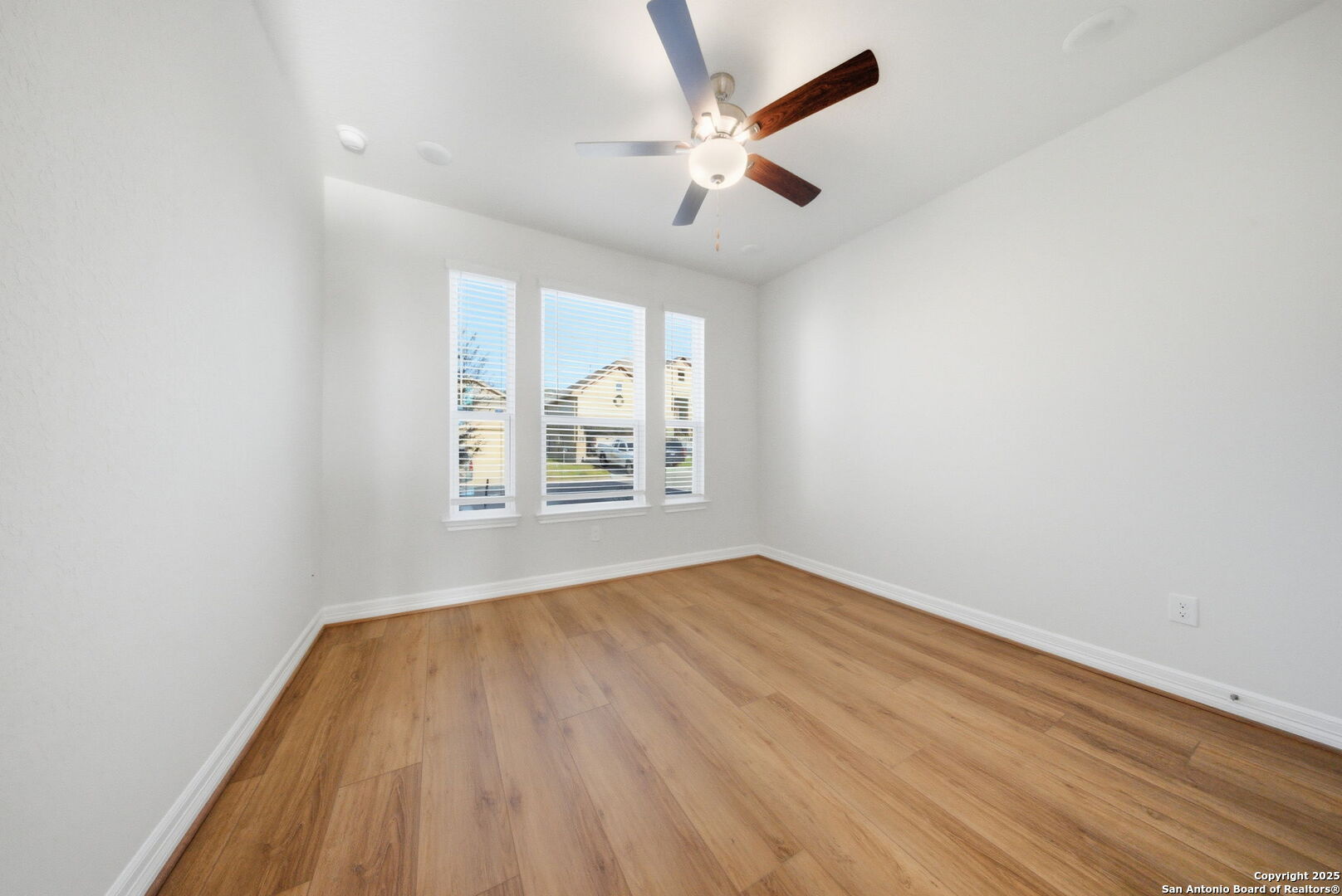 662 Hidden View Street New Braunfels, TX 78130 - Photo 8 of 48 wooden floor in an empty room with a window