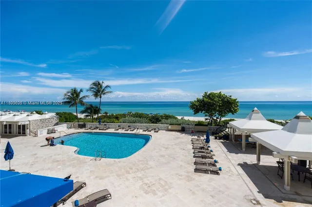 a view of a swimming pool with outdoor seating