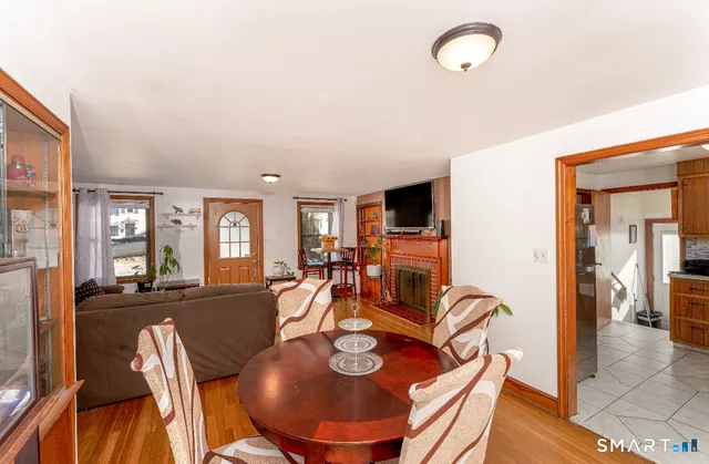 a living room with furniture and a dining table