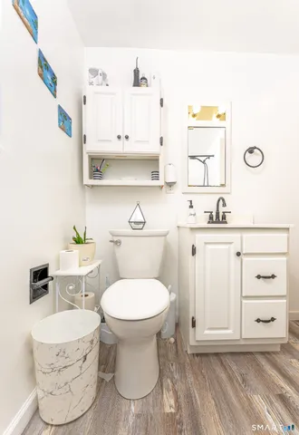 a bathroom with a sink toilet and mirror