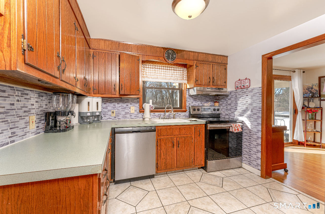 136 Pearl Lake Road Waterbury, CT 06706 - Photo 17 of 35 a kitchen with stainless steel appliances granite countertop a sink stove and cabinets