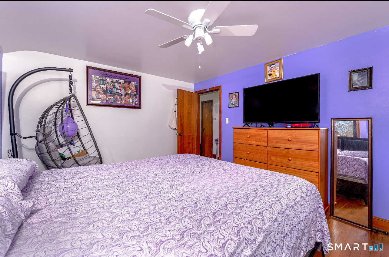 136 Pearl Lake Road Waterbury, CT 06706 - Photo 22 of 35 a bedroom with a bed and a flat screen tv