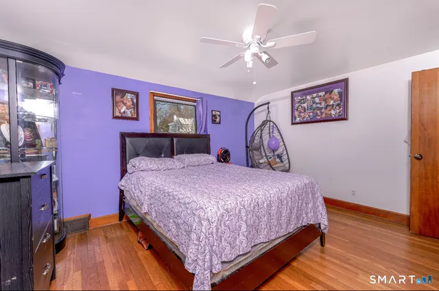 a bedroom with a large bed and a chandelier