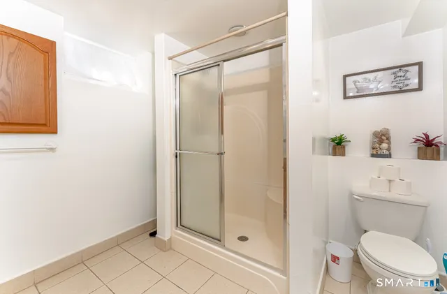 a bathroom with a toilet and a shower