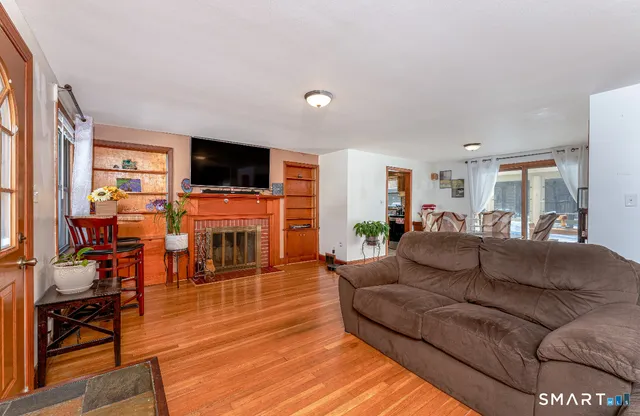a living room with fireplace furniture and a flat screen tv