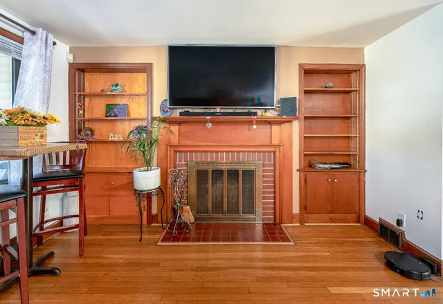 a living room with a flat screen tv and a fireplace