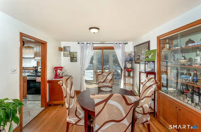 a view of a dining room with furniture window and wooden floor